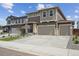 Beautiful two-story home with a two car garage, manicured landscaping, and a cozy front entry at 45915 Wood Thrush Ave, Bennett, CO 80102