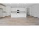 Spacious kitchen boasts a central island, ample cabinet space, and seamless flow into the living area at 45915 Wood Thrush Ave, Bennett, CO 80102
