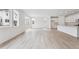 Bright living room offers light floors, white walls, large windows, and an open layout into the kitchen at 45915 Wood Thrush Ave, Bennett, CO 80102