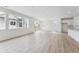 Bright living room with lots of natural light, light wood floors, and a view of the backyard at 45915 Wood Thrush Ave, Bennett, CO 80102