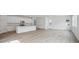 Bright open-concept living room and kitchen area with hardwood flooring and natural light at 45915 Wood Thrush Ave, Bennett, CO 80102