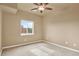 Neutral bedroom with a ceiling fan and large window providing ample natural light at 1144 Rockhurst Dr # 401, Highlands Ranch, CO 80129
