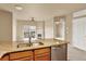 Open kitchen featuring granite counters, stainless steel appliances and seamlessly flowing into the living area at 1144 Rockhurst Dr # 401, Highlands Ranch, CO 80129