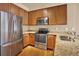 Efficient kitchen showcasing stainless steel appliances, granite countertops, and bright lighting at 1144 Rockhurst Dr # 401, Highlands Ranch, CO 80129