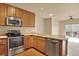 Kitchen with stainless steel appliances, granite counters and wood floors at 1144 Rockhurst Dr # 401, Highlands Ranch, CO 80129