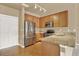 Well-equipped kitchen featuring stainless steel appliances and a breakfast bar area at 1144 Rockhurst Dr # 401, Highlands Ranch, CO 80129