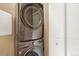 Modern stacked washer and dryer with white doors at 1144 Rockhurst Dr # 401, Highlands Ranch, CO 80129