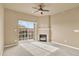 Open living area with fireplace, ceiling fan and a sliding glass door for natural light at 1144 Rockhurst Dr # 401, Highlands Ranch, CO 80129