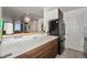 Modern kitchen with white countertops, wood cabinets, and stainless steel appliances at 1020 15Th St # 12C, Denver, CO 80202