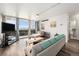 Bright living room featuring hardwood floors, a balcony with views, and comfortable seating at 1020 15Th St # 12C, Denver, CO 80202