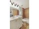Bathroom with a double sink vanity, tile floor, adjacent washer/dryer, and bathtub-shower combo at 3341 S Monaco Pkwy # A, Denver, CO 80222