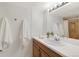 Bathroom vanity with a white countertop and a sink with towels, decoration and view into the shower at 3341 S Monaco Pkwy # A, Denver, CO 80222