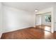 Bedroom featuring hardwood flooring, a mirror closet, and a sunny window with a tree view at 3341 S Monaco Pkwy # A, Denver, CO 80222