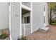 Exterior view showcases neutral siding, a gated patio, and well-maintained landscaping at 3341 S Monaco Pkwy # A, Denver, CO 80222