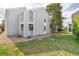 Exterior view of townhome featuring vinyl siding, a small porch, and a large grassy lawn at 3341 S Monaco Pkwy # A, Denver, CO 80222
