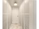 Hallway featuring a large storage closet with louvered doors and neutral-toned flooring at 3341 S Monaco Pkwy # A, Denver, CO 80222