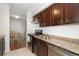 Renovated kitchen with stainless steel appliances, granite countertops, and dark wood cabinets at 3341 S Monaco Pkwy # A, Denver, CO 80222