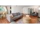 Living room featuring hardwood floors, comfortable seating, and an open dining space at 3341 S Monaco Pkwy # A, Denver, CO 80222