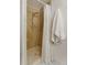 Shower with tan tiled walls and floor with a white shower curtain and a towel hanging nearby at 3341 S Monaco Pkwy # A, Denver, CO 80222