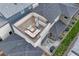 This aerial view showcases the roof top patio and backyard with outdoor seating and a covered grill at 6366 N Emporia St, Denver, CO 80238
