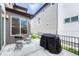Backyard patio with grill, furniture set, privacy fence, and neat landscaping at 6366 N Emporia St, Denver, CO 80238