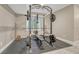 Basement gym featuring a full weight rack, bench, and ample space for workouts at 6366 N Emporia St, Denver, CO 80238