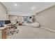 Spacious basement featuring a cozy seating area, workspace, and modern décor at 6366 N Emporia St, Denver, CO 80238