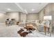 Comfortable basement with sectional sofa, office area, and stylish decor in neutral color palette at 6366 N Emporia St, Denver, CO 80238