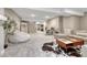 Finished basement featuring large seating area, a workspace, and neutral carpeted floors at 6366 N Emporia St, Denver, CO 80238