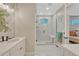 Modern bathroom with sleek fixtures, a glass-enclosed shower with a seating area, and stylish tile work at 6366 N Emporia St, Denver, CO 80238