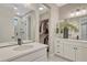Luxurious bathroom with double sink vanity, a walk-in closet, and a glass-enclosed shower, providing a spa-like experience at 6366 N Emporia St, Denver, CO 80238