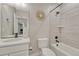 Modern bathroom with sleek vanity, stylish mirror, and tiled shower-tub combination at 6366 N Emporia St, Denver, CO 80238