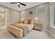 Comfortable bedroom with neutral tones, decorative lamps, and two windows at 6366 N Emporia St, Denver, CO 80238
