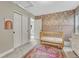 Bedroom featuring a crib, decorated wall, and neutral colored carpeted floors at 6366 N Emporia St, Denver, CO 80238