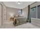 Bedroom with a large bed, side tables with lamps, and a window bringing in natural light at 6366 N Emporia St, Denver, CO 80238