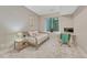 Serene bedroom with neutral tones, a cozy daybed, and a well-lit desk area at 6366 N Emporia St, Denver, CO 80238