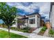 Charming two-story home features a modern design and beautifully landscaped front yard at 6366 N Emporia St, Denver, CO 80238