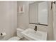 Clean half bath features a modern sink, decorative mirror, and framed artwork at 6366 N Emporia St, Denver, CO 80238