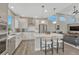 Stylish kitchen with stainless steel appliances, white cabinetry, and island seating at 6366 N Emporia St, Denver, CO 80238
