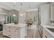 Bright kitchen with white cabinetry, quartz countertops, and an island, offering ample space for cooking and entertaining at 6366 N Emporia St, Denver, CO 80238