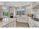 Contemporary kitchen with stainless steel appliances, white cabinets, and island with stools at 6366 N Emporia St, Denver, CO 80238