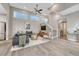 Open living room features high ceilings, a modern ceiling fan, and large windows at 6366 N Emporia St, Denver, CO 80238