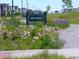 Bison Passage park sign surrounded by colorful flowers along a path in this beautiful Denver park at 6366 N Emporia St, Denver, CO 80238