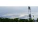 View of a stadium featuring a towering light fixture, trees and businesses in a community setting at 6366 N Emporia St, Denver, CO 80238