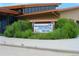 Rocky Mountain Arsenal National Wildlife Refuge Visitor Center sign amidst lush green foliage and mature landscaping at 6366 N Emporia St, Denver, CO 80238