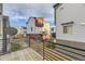 Balcony view of modern townhomes, wooden fence, green space, and blue sky at 2564 Sweet Wind Ave, Castle Rock, CO 80109