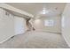 Finished basement with carpet, white doors, window and access to the stairs at 2564 Sweet Wind Ave, Castle Rock, CO 80109