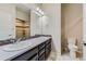 Double vanity bathroom features framed mirrors, granite countertops, and tiled shower at 2564 Sweet Wind Ave, Castle Rock, CO 80109