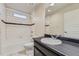 Bathroom with white tiled shower and black accent stripe with black vanity and sink at 2564 Sweet Wind Ave, Castle Rock, CO 80109
