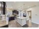 Kitchen featuring dark cabinetry, granite countertops, a spacious island with pendant lighting, and stainless-steel appliances at 2564 Sweet Wind Ave, Castle Rock, CO 80109